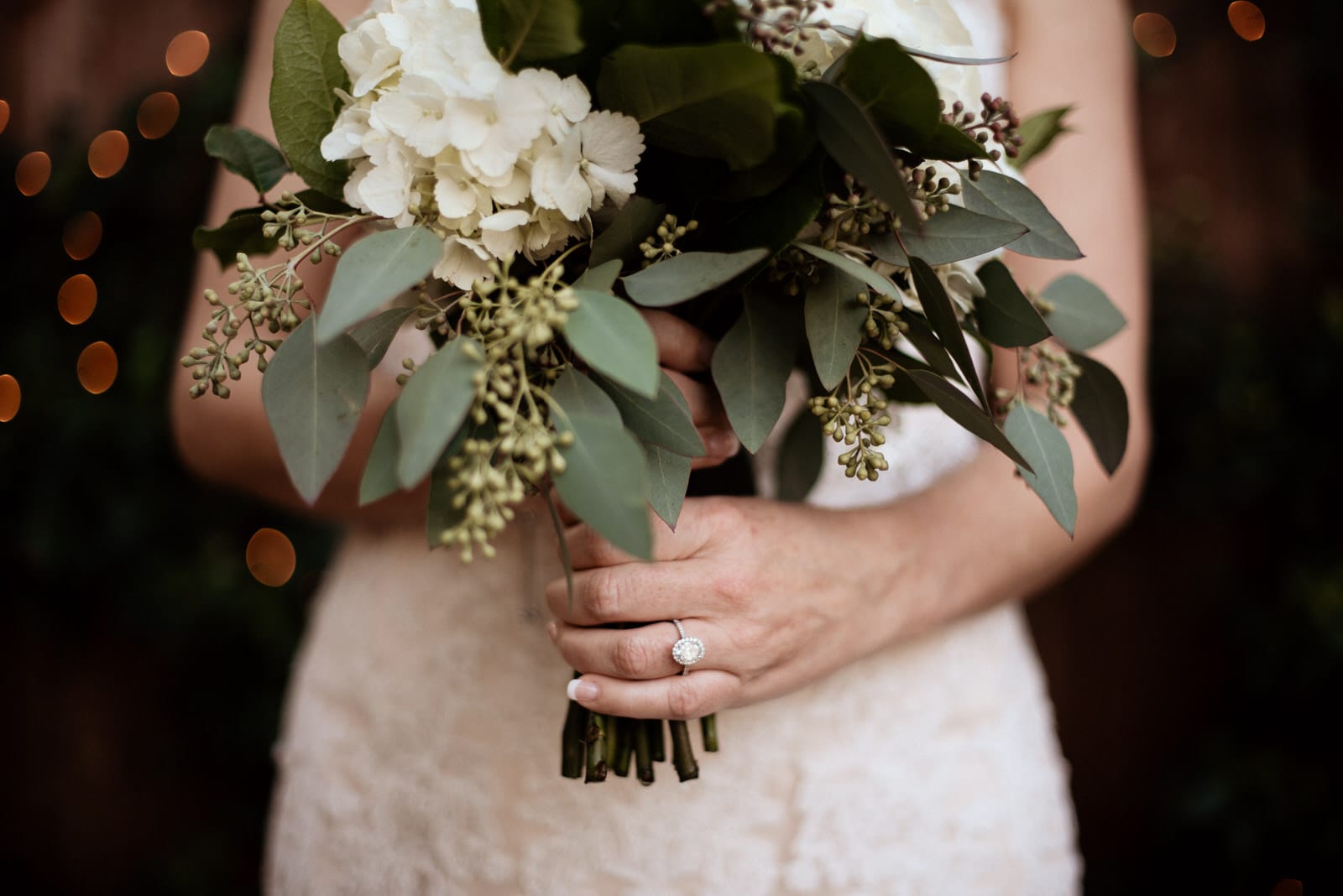 Wedding ring detail with bouquet 