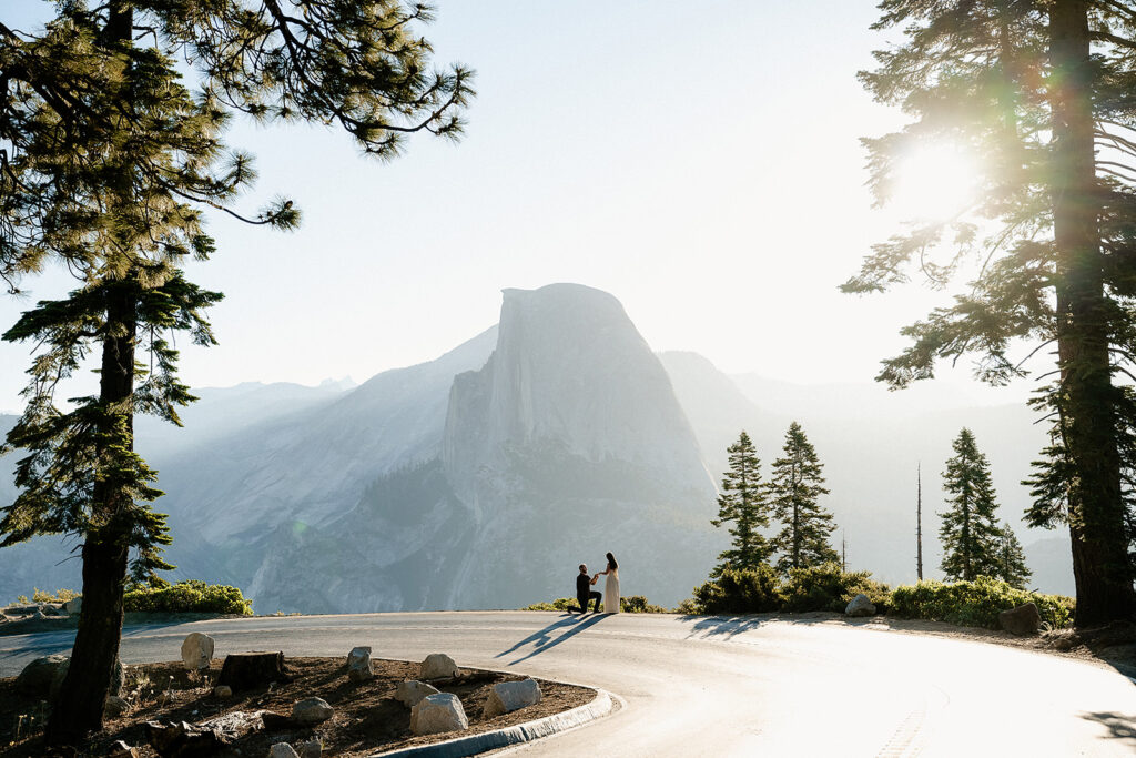 couple proposing engagement in the mountains