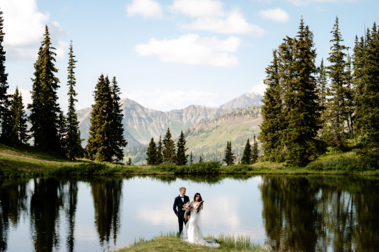 bride and groom at a lake in Colorado