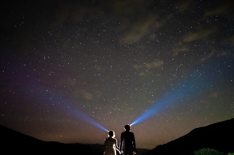 a bride and groom stargazing during their elopement