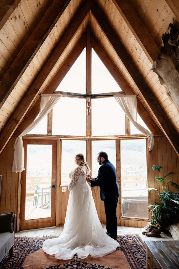 bride and groom getting ready for their wedding in an A-Frame AirBnB