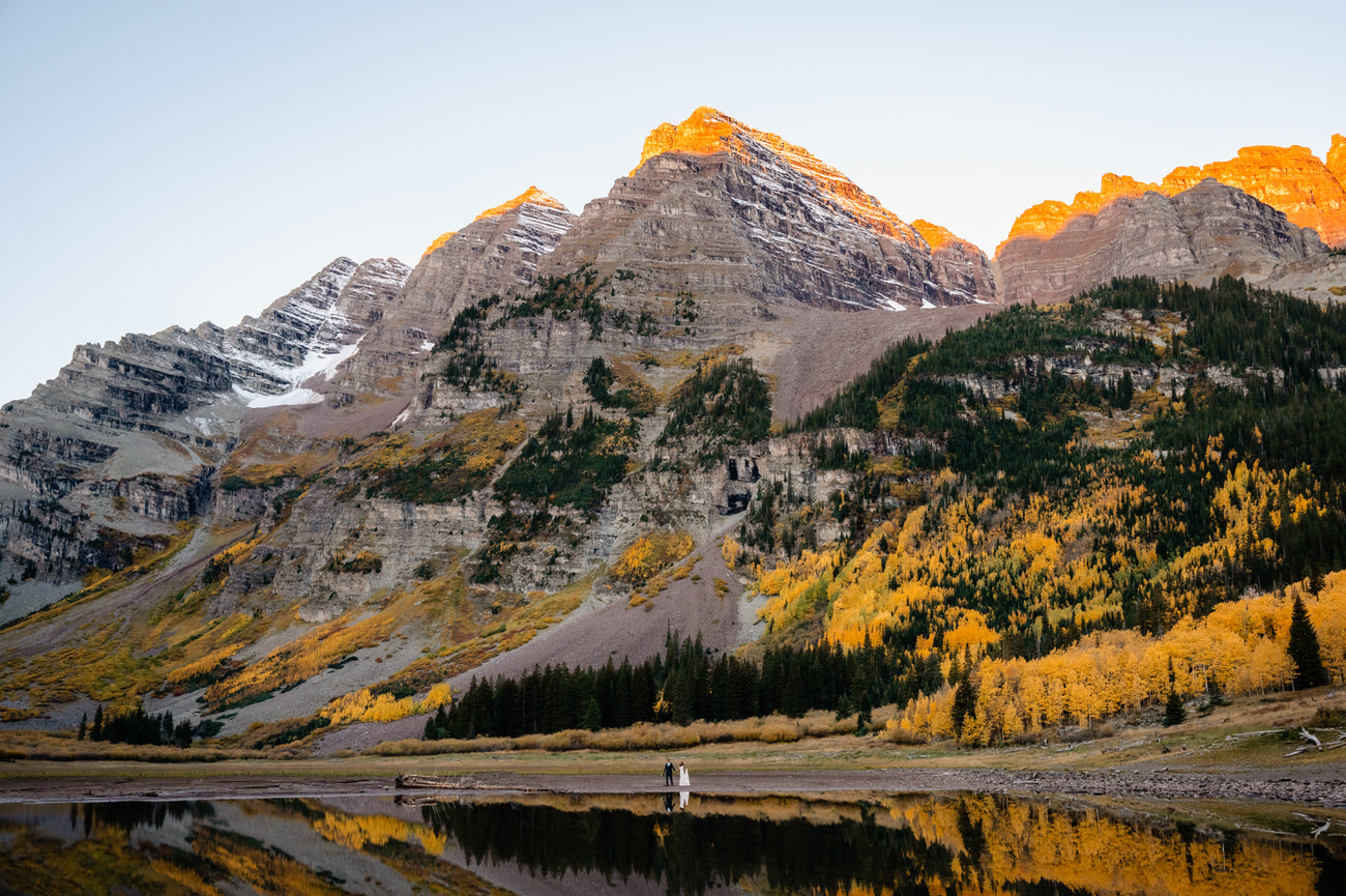 a couple getting married in front of a mountain at Maroon Bells Colorado in the fall