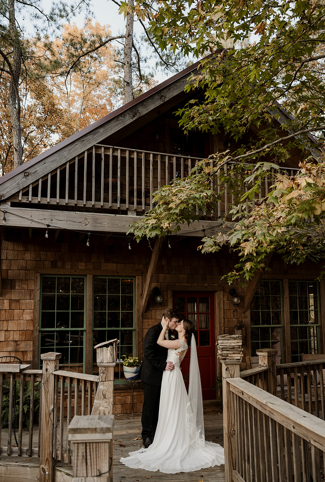 bride and groom kissing outside a unique VRBO wedding venue