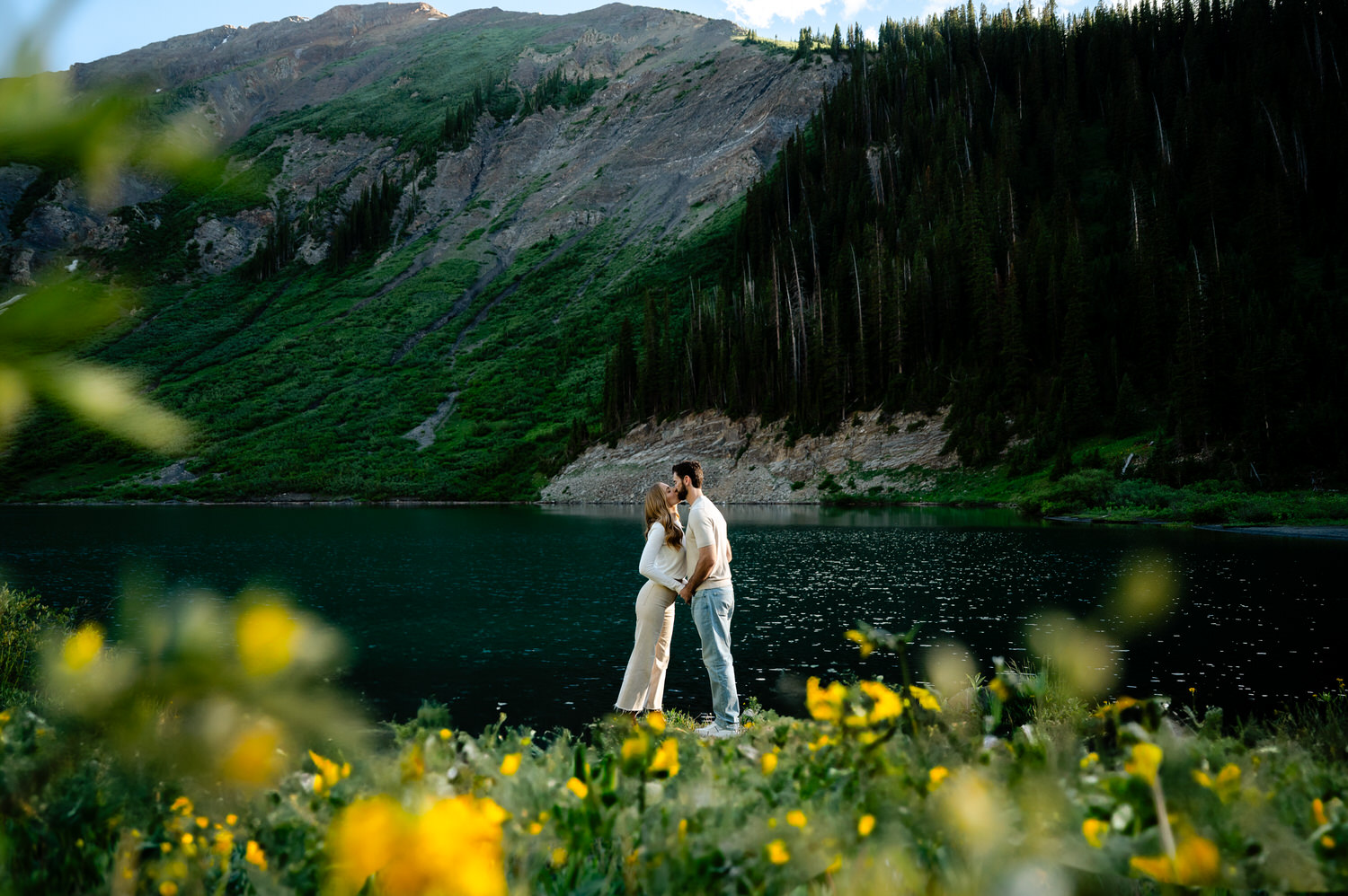 Couple embracing by serene lake