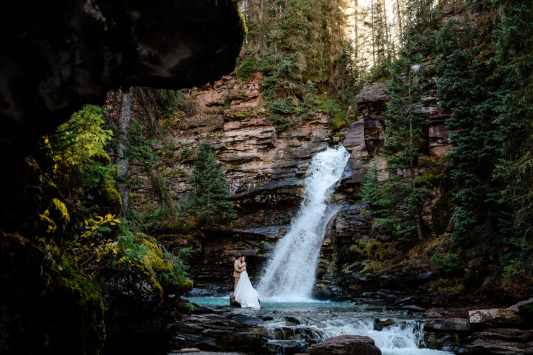 eloping couple at a waterfall