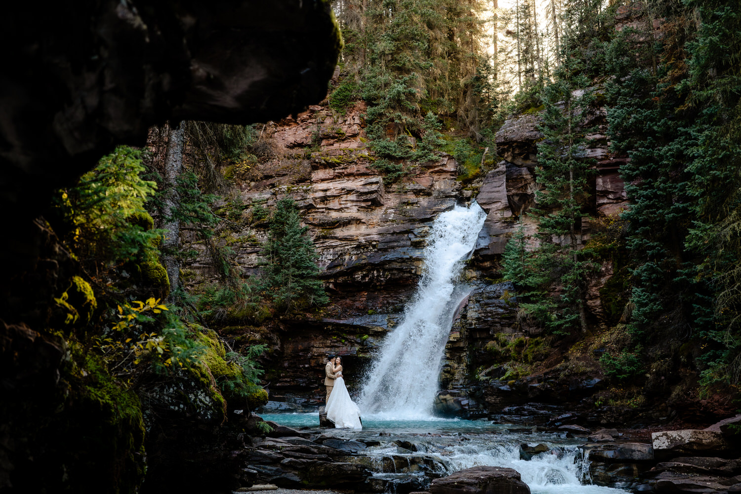 eloping couple at a waterfall
