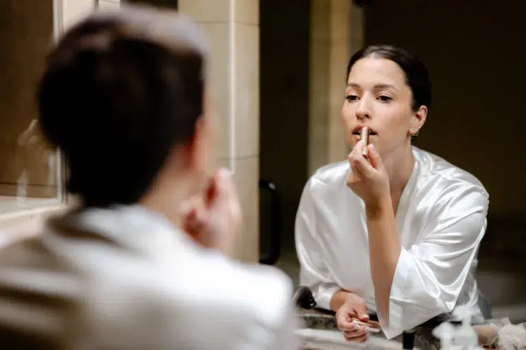 bride putting on lipstick